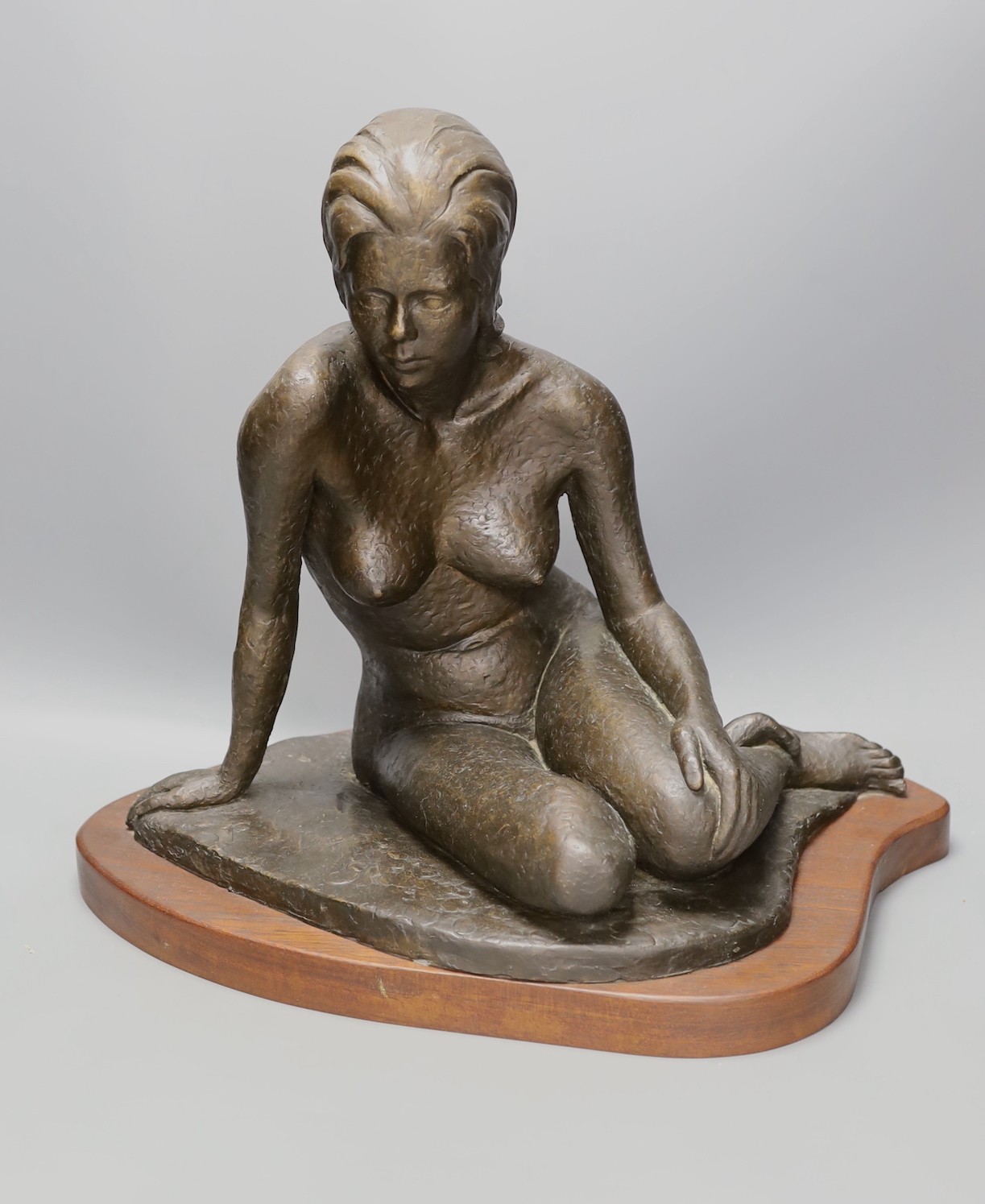 Audrey Shaw. A bronzed resin figure of a seated girl, 43cm tall